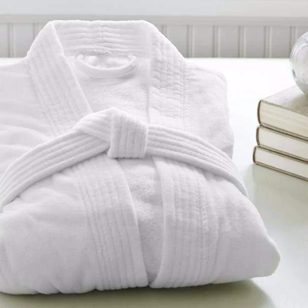 Folded white bathrobe